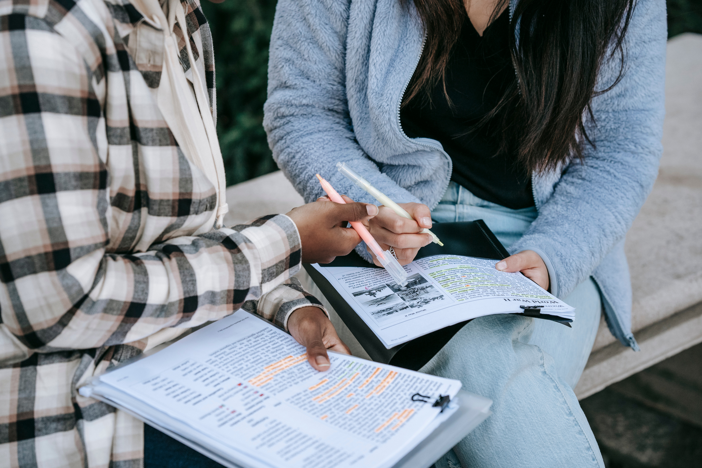 Crop diverse students taking notes